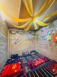 a bed in a room with a ceiling with curtains at Mj s Home in Kalgha +49 photos