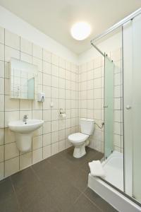 a bathroom with a toilet and a sink and a shower at Marina Grudziądz in Grudziądz +26 photos