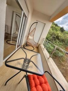 a balcony with chairs and a window on a porch at Maison Budva in Bečići