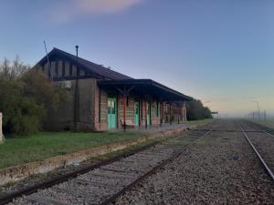 a train station with train tracks in front of it at La Pradera in Tres Picos