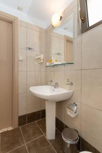 a bathroom with a sink and a mirror at Finiki Plaza in Methoni +185 photos