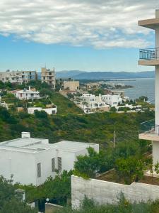 a view of a city with buildings and the ocean at Meintis Apartments Rafina in Rafina