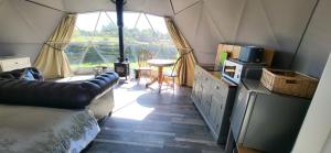 a room with a couch and a table in a tent at alpaca view Dome in New Holland