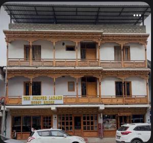 a building with a sign that reads the timber lungs guest house at The Juniper Ladakh Guest House in Kargil