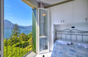 a bedroom with a bed and a balcony with a view at Bella Vista in Varenna