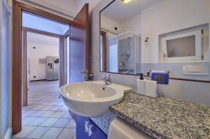 a bathroom with a sink and a large mirror at Bella Vista in Varenna +16 photos