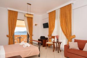 a hotel room with a bed and a couch at Finiki Plaza in Methoni