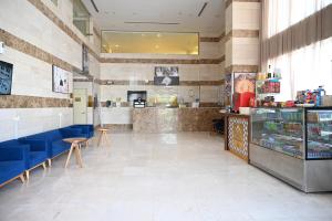 a restaurant with blue chairs and a counter at فندق دوما - Domma hotel in Medina