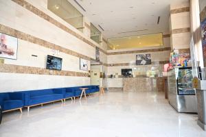 a restaurant with blue benches and a counter at فندق دوما - Domma hotel in Medina