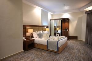 a hotel room with a large bed and a mirror at فندق دوما - Domma hotel in Medina +83 photos