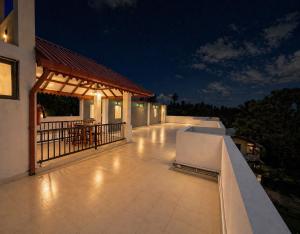 a balcony of a house at night with lights at Hotel Dreamliners in Katunayaka