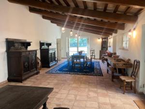a living room with a table and a dining room at Antico Casale Mevania in Bevagna