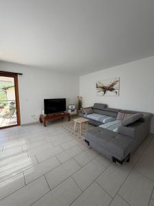 a living room with two couches and a tv at Appartamento sole in Isone