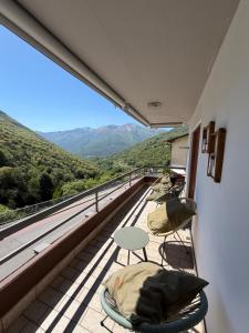 a balcony with chairs and a table and a view at Appartamento sole in Isone