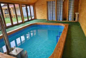a swimming pool in the middle of a house at Casa Marinca in Ocna Şugatag