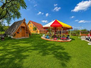 a playground with a tent and a house at Casa Marinca in Ocna Şugatag