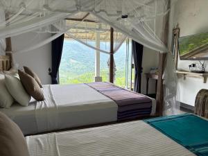 two beds in a room with a large window at Leaf Olu Ella in Yatiyantota +98 photos
