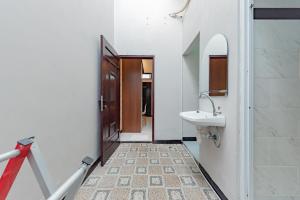 a bathroom with a sink and a mirror at RedDoorz Plus at Orange Diponogoro Palangkaraya in Palangkaraya