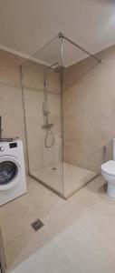 a glass shower in a bathroom with a toilet at Endless Blue in Pythagoreio +27 photos