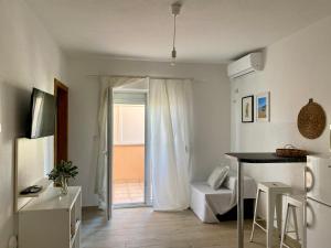 a living room with a table and a door to a patio at Apartments Ivana in Zubovići