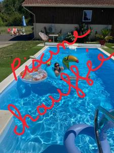 a person in a swimming pool with a happy new year sign at MAISON PRATS in Audon +8 photos