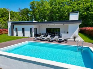 a pool in the backyard of a house at Villa Tomaté in Velika Buna