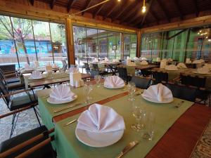 a restaurant with tables with napkins and glasses on them at Oscar Boutique Hotel in Antalya