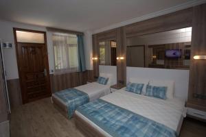 a hotel room with two beds and a mirror at Oscar Boutique Hotel in Antalya