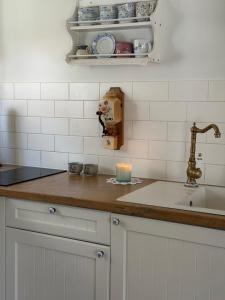 a kitchen with a sink and a candle on a counter at Charzykówka Domek na Kaszubach in Charzykowy