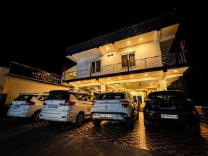 three cars parked in front of a building at night at Hotel Suryavansham in Gupta Kāshi