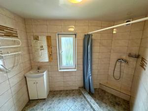 a bathroom with a shower and a toilet and a sink at Pas Aldoną in Šventoji +61 photos