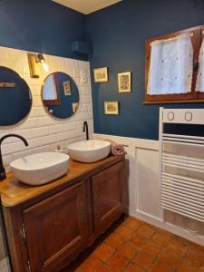 a bathroom with two sinks on a wooden counter at La maison Argonnaise in beaulieu en argonne +31 photos