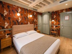 a bedroom with a large bed in a room at Hôtel de Notre-Dame in Paris