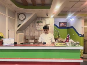 a man standing at a counter in a lego kitchen at Hotel Best Ocean in Kathmandu