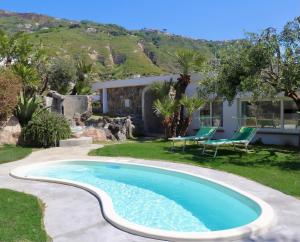a swimming pool in a yard with a house at Sorgeto Garden in Forio d'Ischia