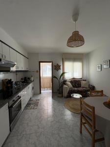 a kitchen and living room with a couch and a table at El paraíso in Raxó