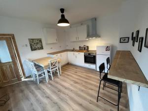 a kitchen and dining room with a table and chairs at Privatzimmer auf Pferdehof in Vŭbel +17 photos
