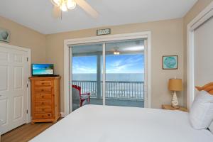 a bedroom with a bed and a view of the ocean at Beach Blessing by Pristine Property Vacation Rentals in Cape San Blas +39 photos