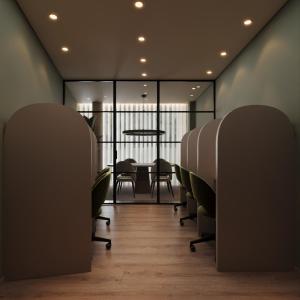 a conference room with green chairs and a table at INOTEL Paços de Ferreira in Paços de Ferreira