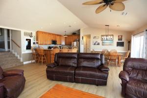 a living room with a couch and a kitchen at Buckleys Beach House by Pristine Property Vacation Rentals in Indian Pass
