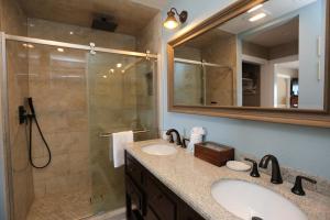 a bathroom with two sinks and a shower at Buckleys Beach House by Pristine Property Vacation Rentals in Indian Pass +34 photos