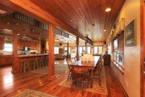 a kitchen and dining room with a wooden table and chairs at Hatchling Hideaway by Pristine Property Vacation Rentals in Indian Pass
