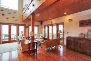 a living room with a table and chairs and a couch at Hatchling Hideaway by Pristine Property Vacation Rentals in Indian Pass +38 photos