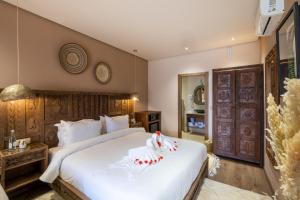 a bedroom with a large bed with white sheets at La Kasbah d'Ourika - Hôtel Restaurant & Spa in Ourika +42 photos