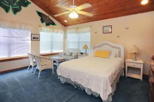 a bedroom with a bed and a table and chairs at Hatchling Hideaway by Pristine Property Vacation Rentals in Indian Pass