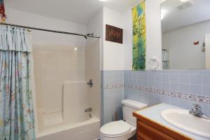 a bathroom with a toilet and a sink and a shower at Hatchling Hideaway by Pristine Property Vacation Rentals in Indian Pass