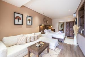 a living room with a couch and a bed at La Kasbah d'Ourika - Hôtel Restaurant & Spa in Ourika
