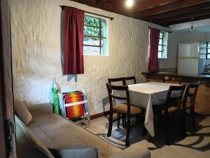 a living room with a table and a couch at Apartamentos do Centrinho do Rosa in Imbituba