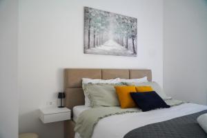 a bedroom with a bed with a painting on the wall at Villa Tomaté in Velika Buna +66 photos