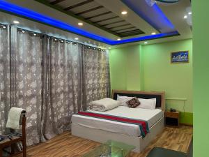 a bedroom with a bed in a room with green walls at Hotel Best Ocean in Kathmandu